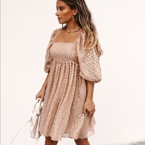 NWT. Tan babydoll dress with sheer puff sleeves and abstract metallic print.